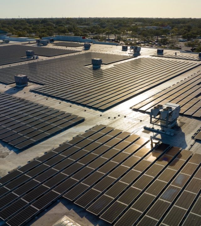 Aerial,View,Of,Blue,Photovoltaic,Solar,Panels,Mounted,On,Industrial